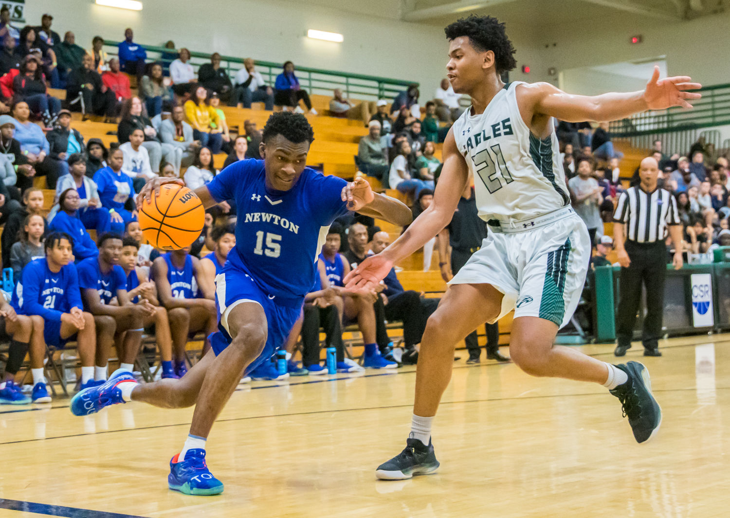 Newton's Qua Brown drives to the basket against Collins Hill